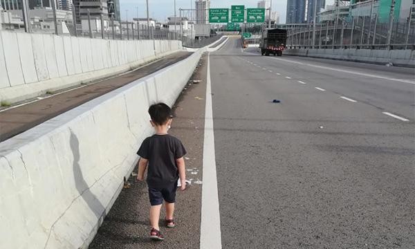 Pregnant woman walks across Causeway with toddler