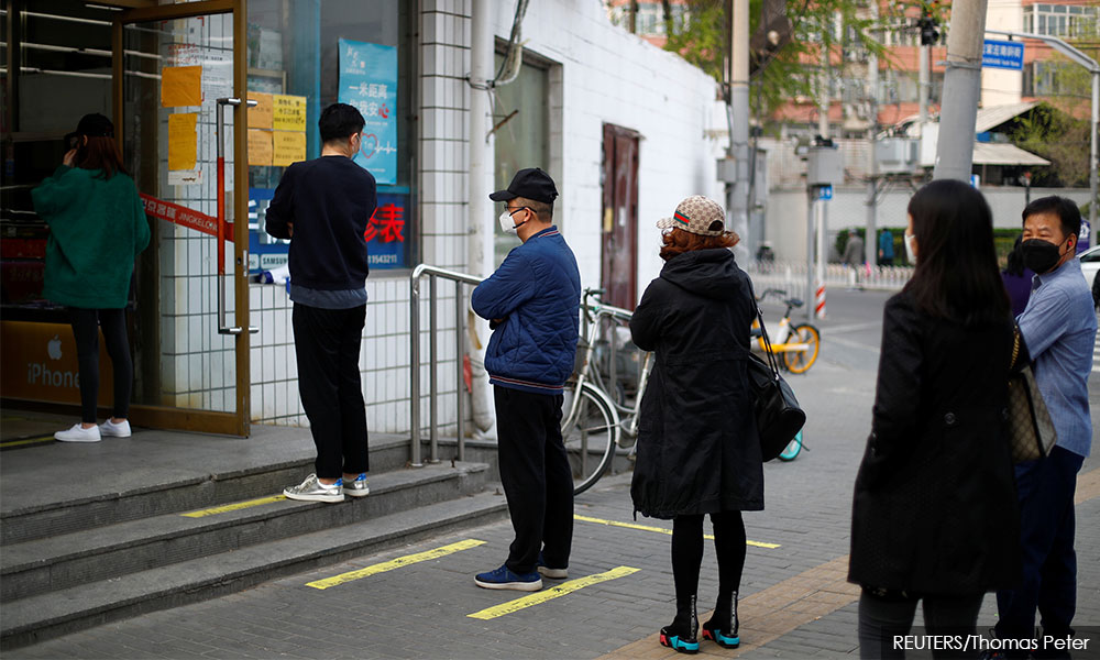 China has fewer new Covid-19 infections, starts posting symptom-free tally
