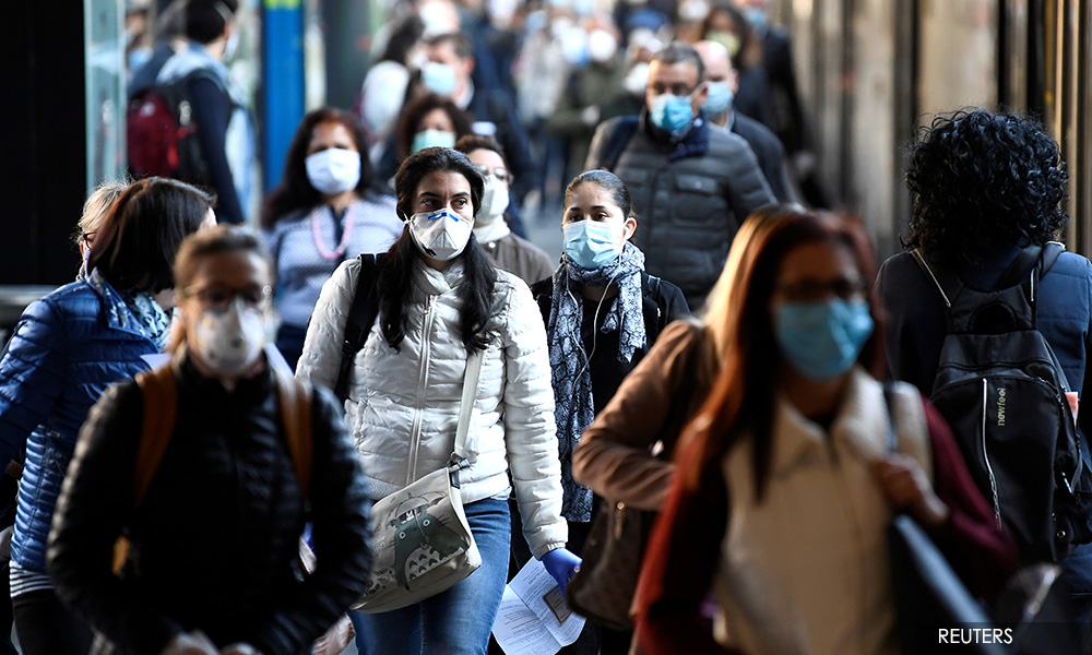 Masked and standing apart, the world tiptoes out of lockdown