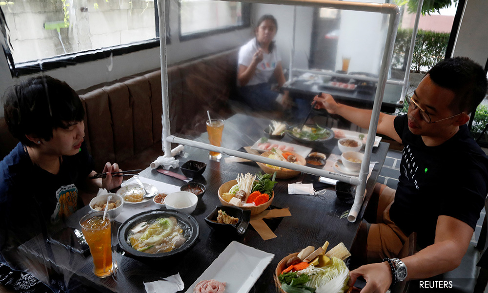 Bangkok reopens with plastic screens between diners, hair stylists in scrubs