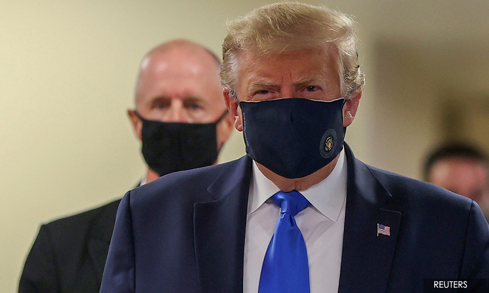 In first, Trump dons mask in visit to military medical facility