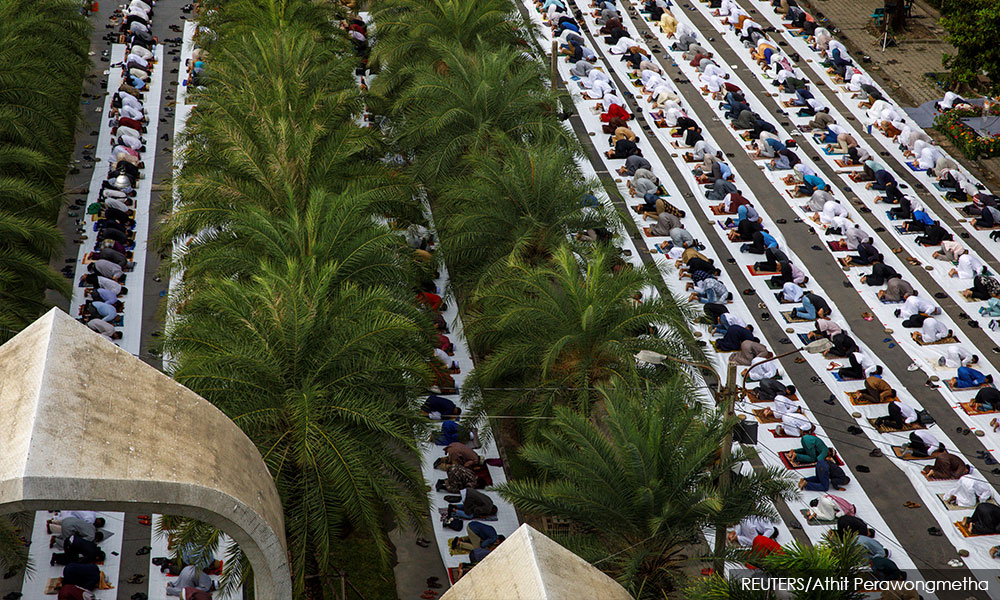 Muslims perform Eid prayers, socially distanced and masked