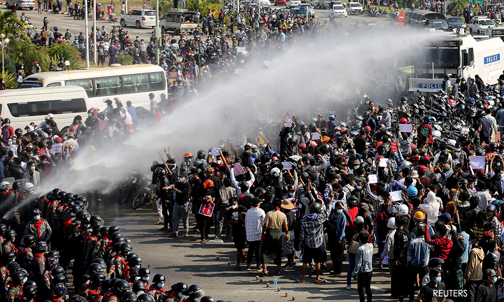Dozens arrested as Myanmar protesters defy bans and water cannons