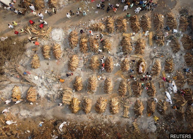 India infections top 18 million as gravediggers work round the clock