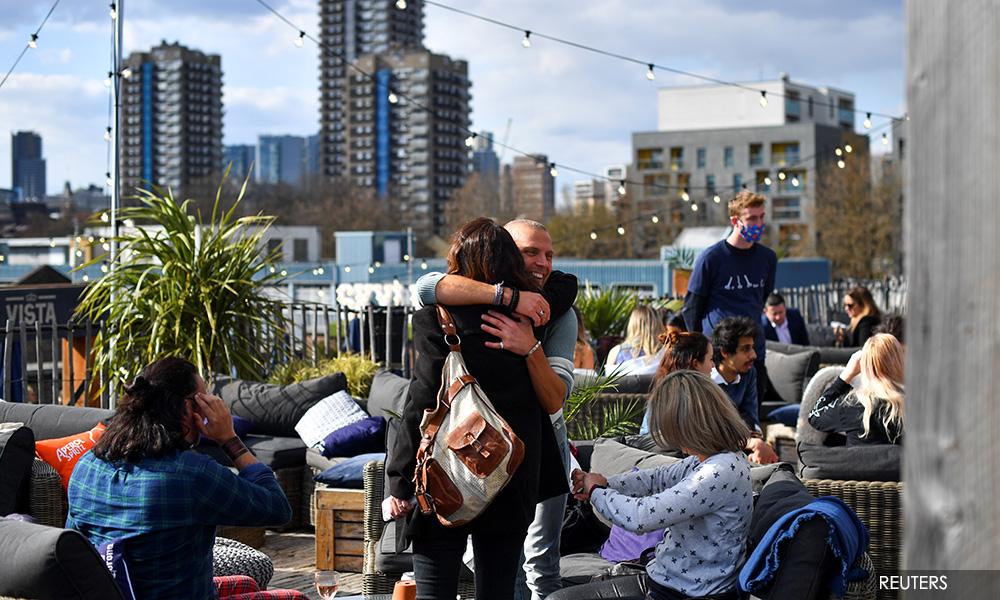 'Cautious hugging' and pints: UK PM Johnson to ease England's lockdown