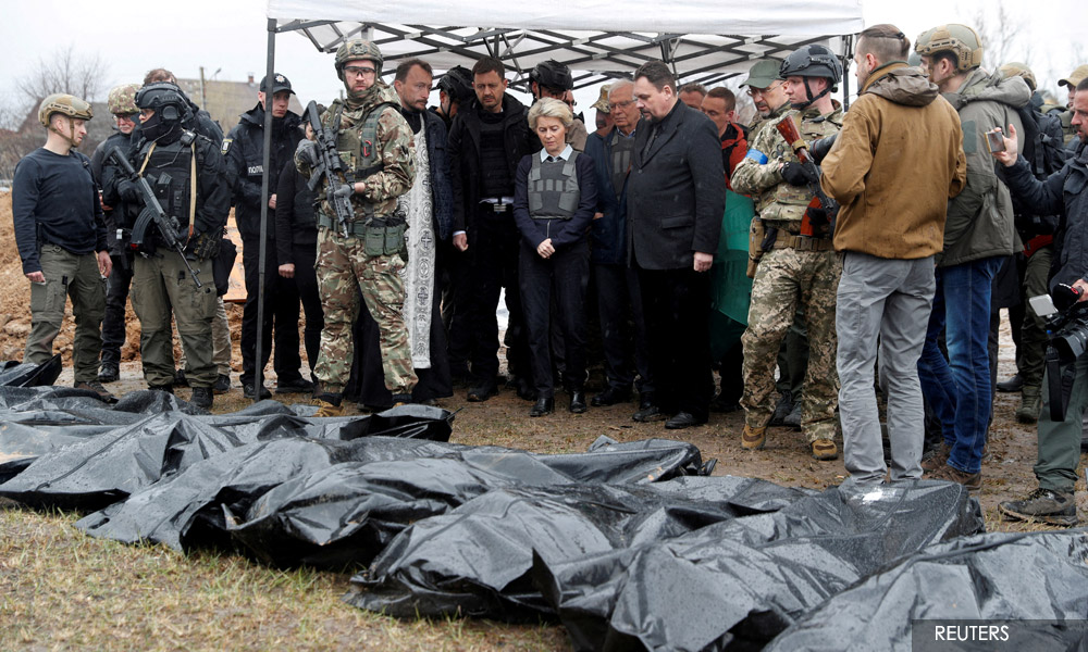 Dozens of civilians found in grave near Kyiv as battle looms in east