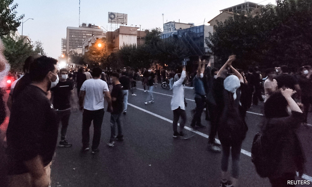 Iranian protesters set fire to police station as unrest over woman's death spreads
