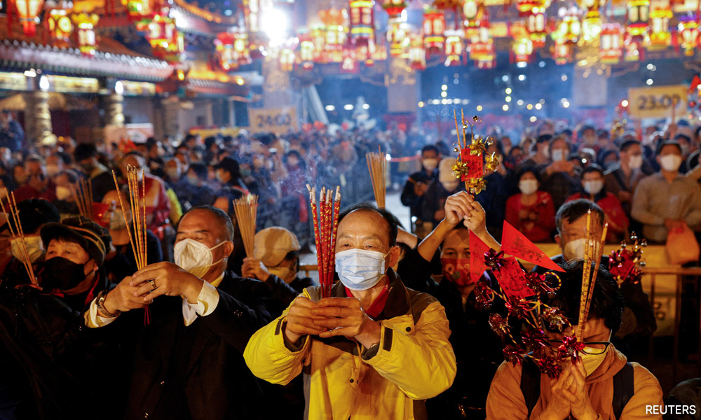 Chinese pray for health in new year as Covid death toll rises