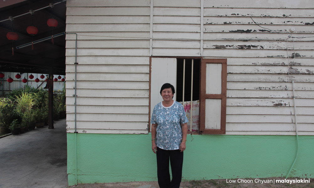 Dorris Lee and her house in Chitty Village.