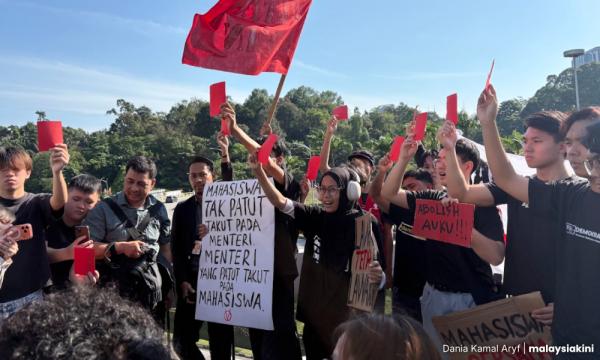 Student protesters flash red cards at Adam during anti-UUCA rally Dania Kamal Aryf 2 h ago ⋅ 3